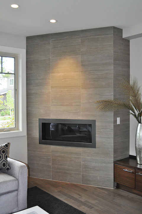 Floor-to-ceiling contemporary fireplace column in large-format tile